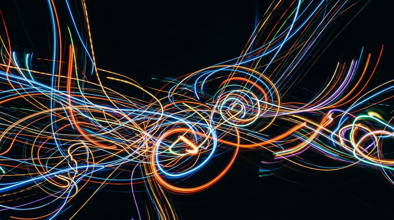 Long exposure photograph showing light trails and patterns in darkness, LED light streaks, abstract colorful lines